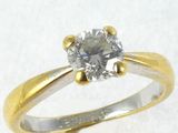 a ring with a diamond on it on a white surface