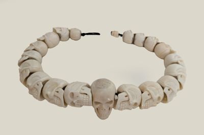 bracelet made of bone beads with a skull head on a string