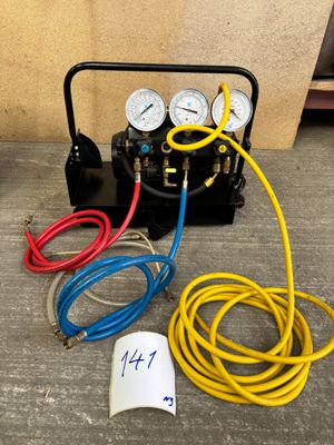 an image of a couple of air compressors with hoses and gauges