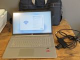 a laptop computer sitting on a wooden table with a bag