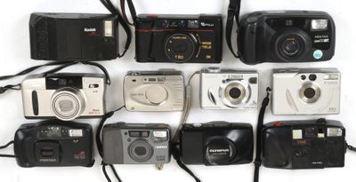 a lot of cameras that are lined up on the table