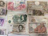a lot of different bank notes on the table