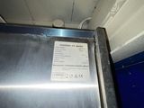 an image of a stainless steel refrigerator in a room