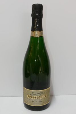 the bottle of champagne is sitting on the table next to the wall