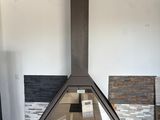 a fireplace in the middle of a living room with a wood floor