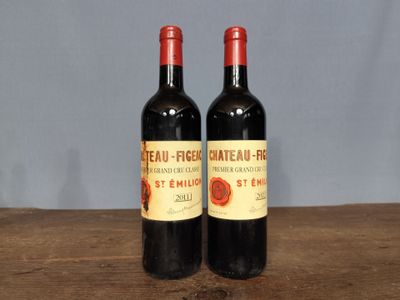 two bottles of wine sitting on a wooden table