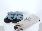a pair of sandals and a towel on a white table