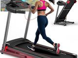 the woman is running on the tread machine in front of the monitor