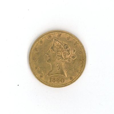a gold coin on a white surface with a lady ' s head on it