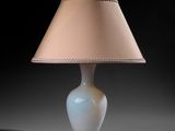an image of a white table lamp with a beige shade on it