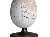 the lamp is on a wooden base with a white shade on it
