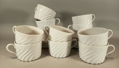 several white coffee cups are stacked on top of each other