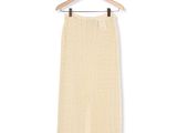 an image of a skirt hanging on a hanger on a white wall