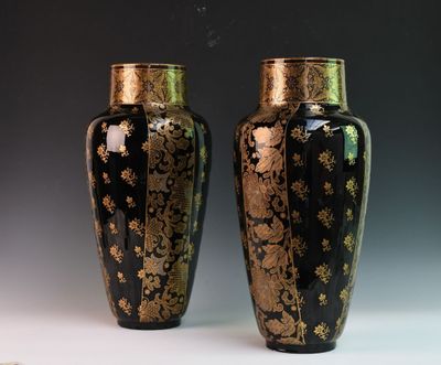 une paire de vases noirs et dorés posés sur une table