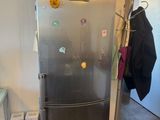 a stainless steel refrigerator in a small kitchen