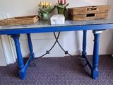 a blue table with a basket of flowers on it