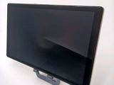 a tablet computer sitting on a stand on a white surface