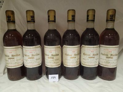 six bottles of wine are lined up in a row on a table