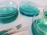 a lot of glass plates and forks on the table