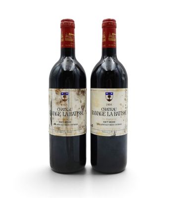 two bottles of wine sitting next to each other on a white surface