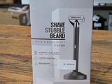the box of a shaver sitting on top of a wooden table