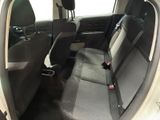 the back seats of a car with a dog standing on the back of it