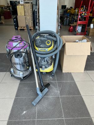 two vacuums that are on the floor in the room