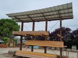 a wooden bench with a roof on top of it