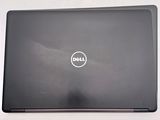 a dell laptop with a dell logo on the screen