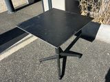 an image of a black table sitting on top of a parking lot