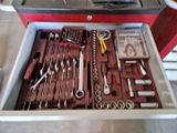 a drawer full of tools that are sitting in a garage