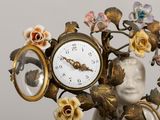 a clock that is sitting on top of a vase