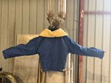 a statue of a man wearing a blue jacket and a yellow scarf