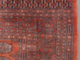 a red and blue rug with a design on it