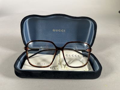 gucci eyeglasses in a case on a white surface