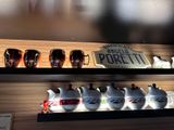 many cups and pitchers on a shelf in a store