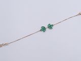 a green butterfly bracelet on a white background