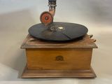an old record player sitting on top of a wooden box