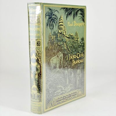 an old book with a picture of a castle and palm trees