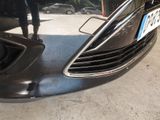 a close up of a car ' s front bumper with a license plate on it