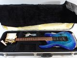 a blue electric guitar in a case on a white background