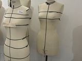 three mannequins are lined up against a wall in a room
