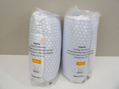two bags of toilet paper sitting on a counter