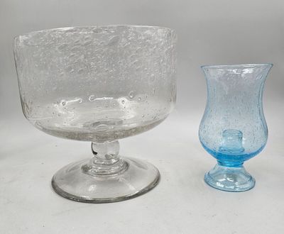 two glass vases sitting next to each other on a table
