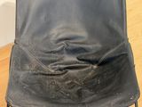 black leather chair with metal frame on wooden floor in room