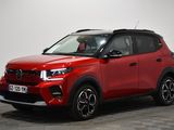 a red toyota rav parked in a room with a checkered floor