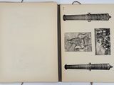 an open book with drawings on it sitting on a table