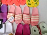 many pairs of slippers that are on a table