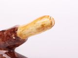 a brown and white animal figurine sitting on a table