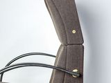 a brown chair with a black seat and a black arm rest